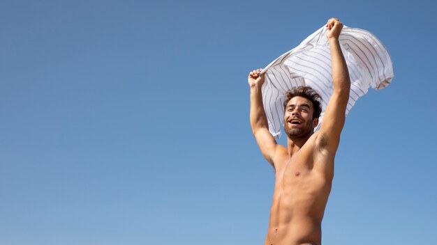 Handsome shirtless male traveler portrait