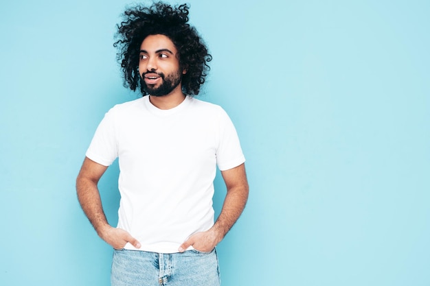 Handsome smiling hipster man posing in studio