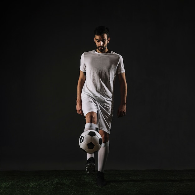 Free photo handsome sportsman juggling ball