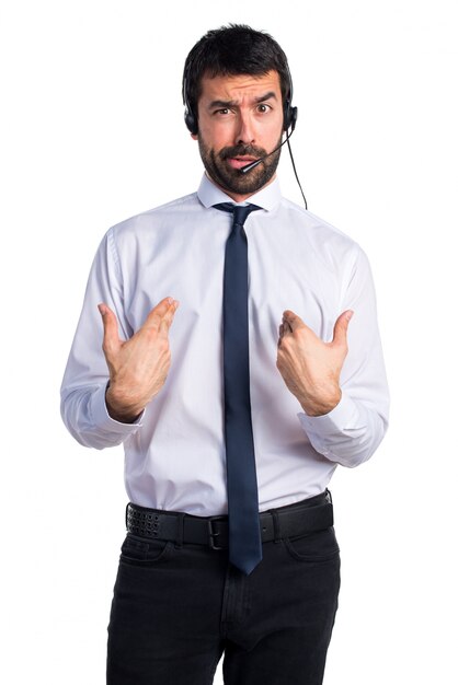 Handsome telemarketer man doing surprise gesture