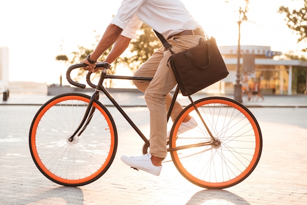 Handsome young african man in early morning with bicycle