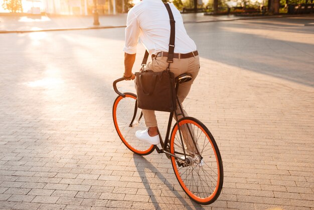 Handsome young african man in early morning with bicycle