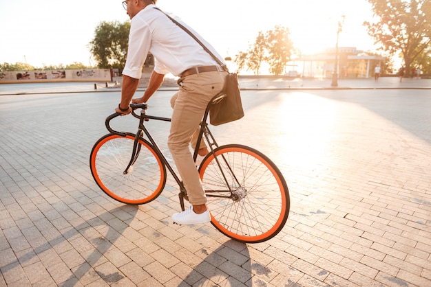 Handsome young african man in early morning with bicycle