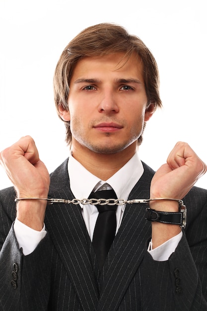 Handsome young businessman portrait with handcuffs