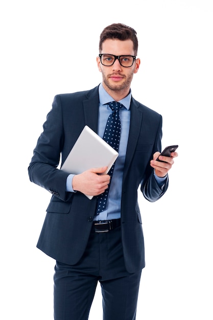 Handsome young businessman with a digital tablet and mobile phone