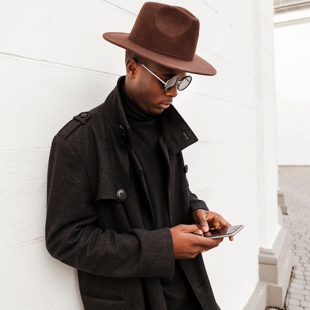 Handsome young male texting on his mobile phone