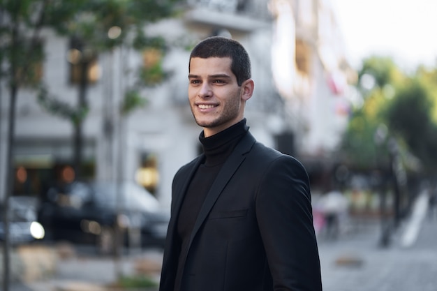 Handsome young male walking on the street