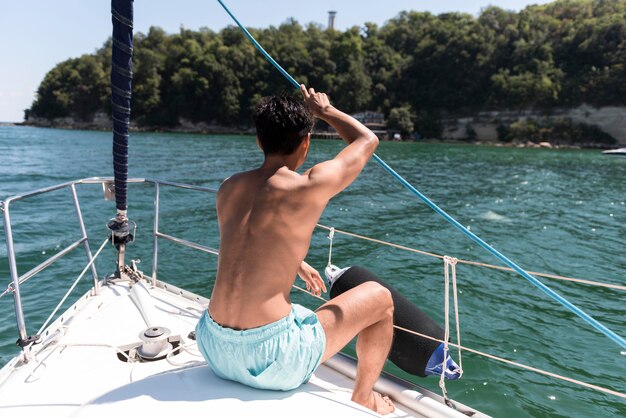 Handsome young man enjoying time on boat