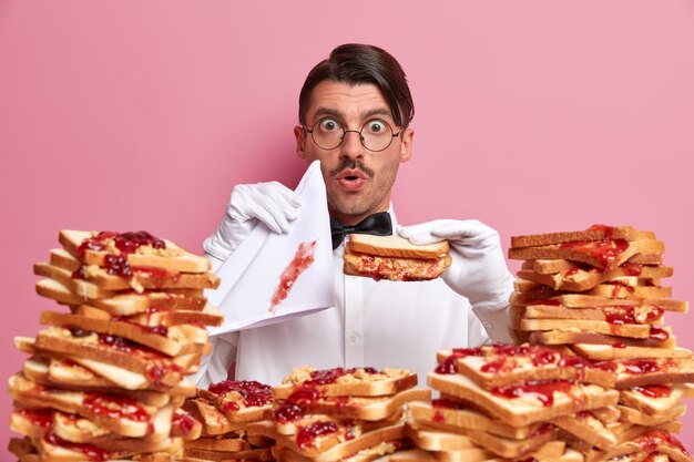 Free Photo handsome young man surrounded by peanut butter jellly sandwiches