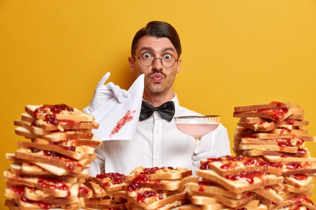 Handsome young man surrounded by peanut butter jellly sandwiches