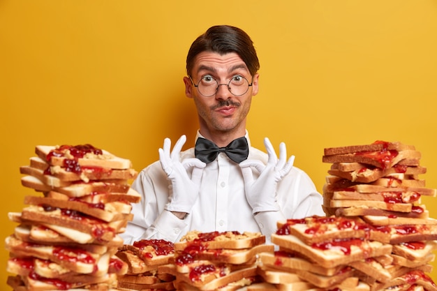 Free Photo handsome young man surrounded by peanut butter jellly sandwiches