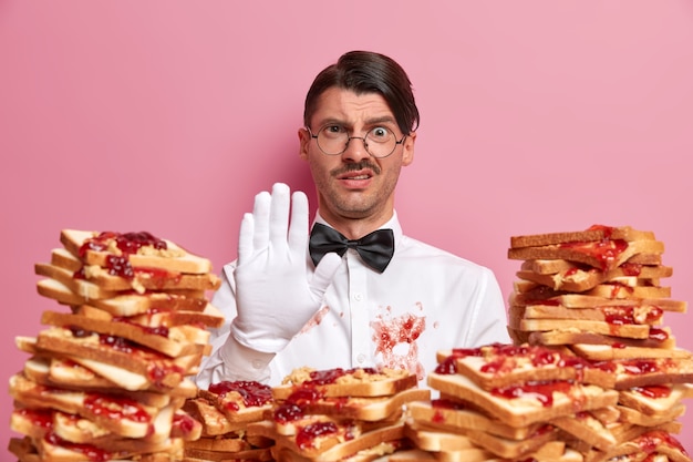 Handsome young man surrounded by peanut butter jellly sandwiches