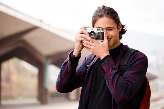 Handsome young man taking a picture