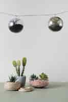 Free photo hanging glass ornaments with minimal vases