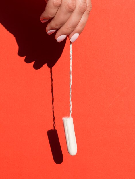 Hanging tampon held by hand