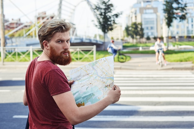 Free Photo hansome man with big beard in red t shirt walk in the city to learn more about it