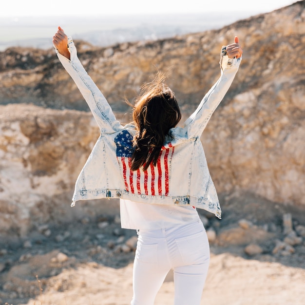 Free Photo happy adult woman raising hands on mountain