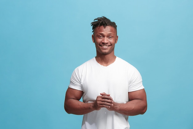 The happy afro-american business man standing and smiling against blue background.