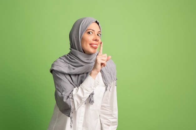 Happy arab woman in hijab. Portrait of smiling girl, posing at studio background