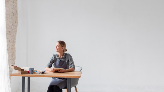 Free photo happy artist sitting copy space