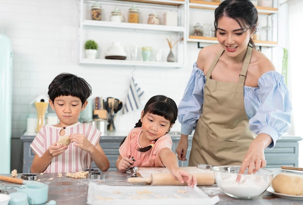 Happy Asian family making food in kitchen at home Enjoy family activity together