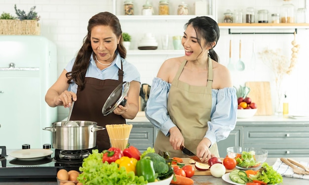 Happy Asian family making food in kitchen at home Enjoy family activity together