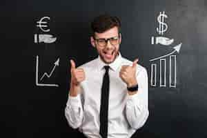 Free photo happy attractive businessman in white shirt showing thumb up gesture with two hands