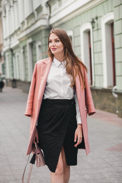 Free photo happy attractive stylish smiling woman walking city street in pink coat spring fashion trend, elegant style