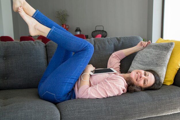 Happy attractive young woman listening to music