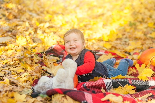 Happy baby playing with teddy bear 