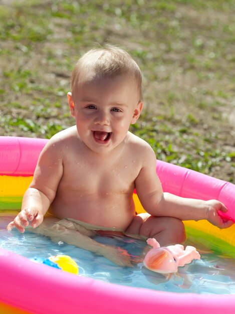 Happy baby swimming  in kid inflatable