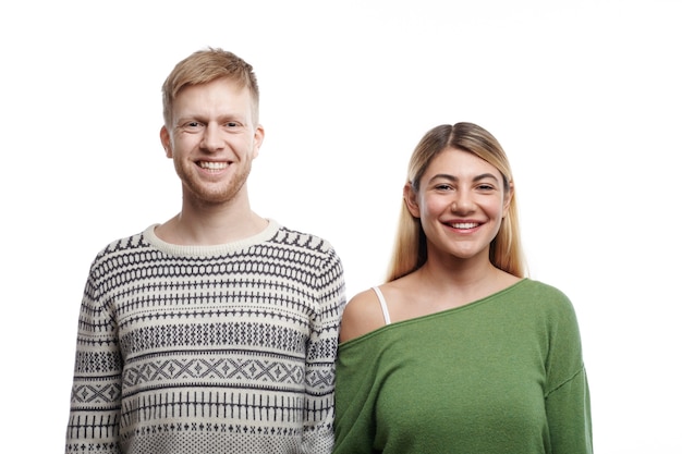 Happy to be together. Isolated portrait of beautiful young Caucasian couple man and woman in love smiling cheerfully