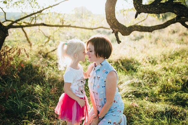 Happy beautiful family on the big garden on the dawn time