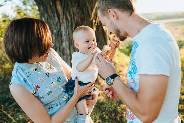 Happy beautiful family on the big garden on the dawn time