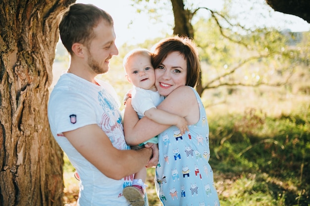 Free photo happy beautiful family on the big garden on the dawn time