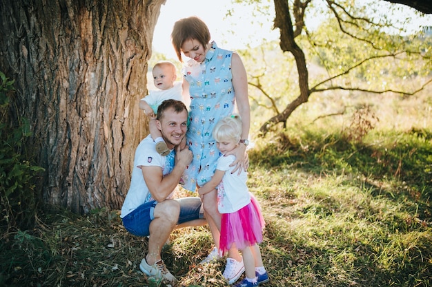 Happy beautiful family on the big garden on the dawn time.