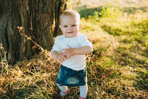 Happy beautiful kid on the big garden on the dawn time