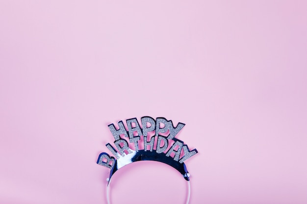 Free photo happy birthday crown on pink background