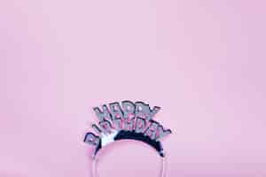 Free photo happy birthday crown on pink background