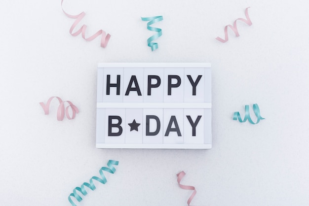 Free photo happy birthday lettering decorated with ribbons