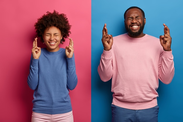 Happy black students cross fingers wait for examination results, pray to get best grade