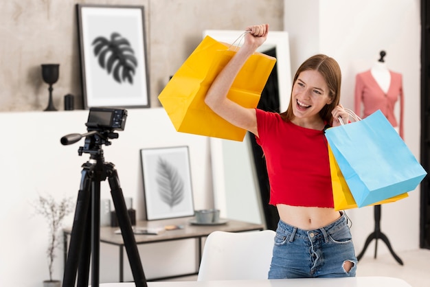 Free Photo happy blogger holding shopping bags