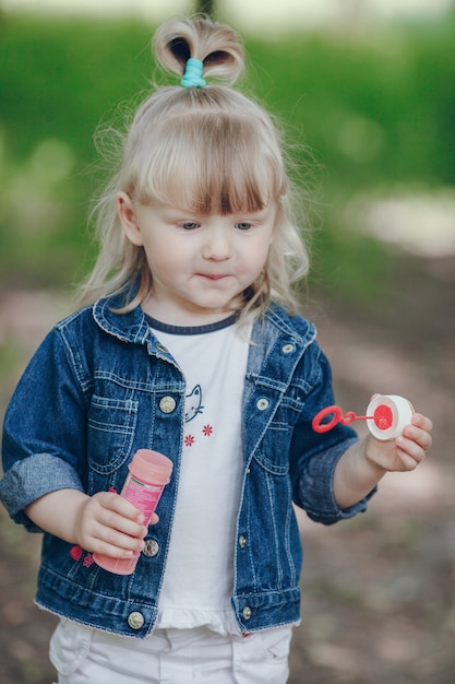 Free photo happy blond girl with a pompous in hands