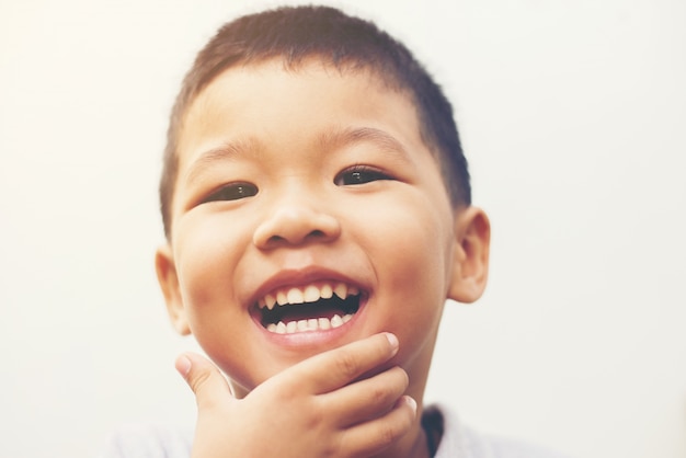 Happy boy laugh looking at camera portrait with isolate white ba