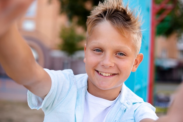 Happy boy taking a selfie on the playground