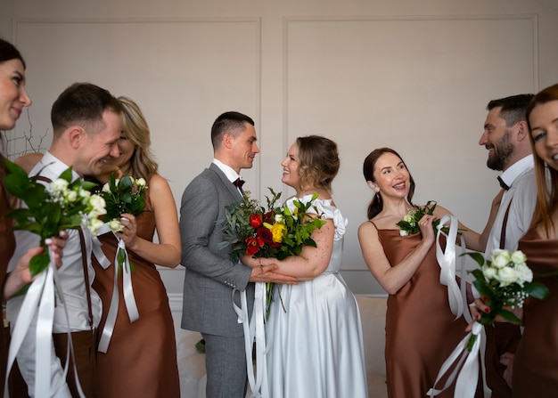 Free photo happy bride and groom with people at wedding ceremony