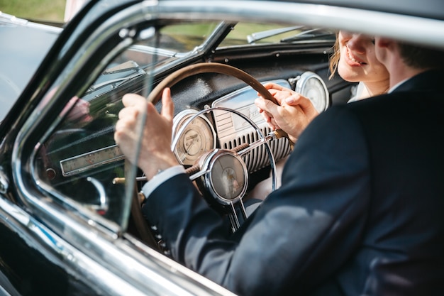 Free photo happy brides are riding in retro cars