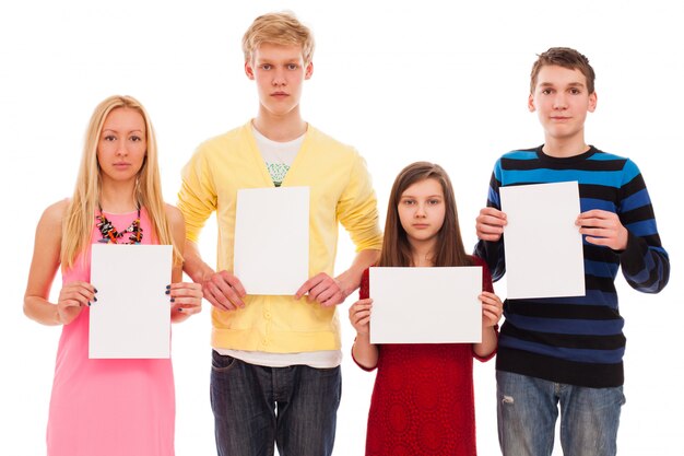 Happy brothers and sisters with empty paper