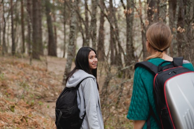 Happy brunette girl looking at her friend