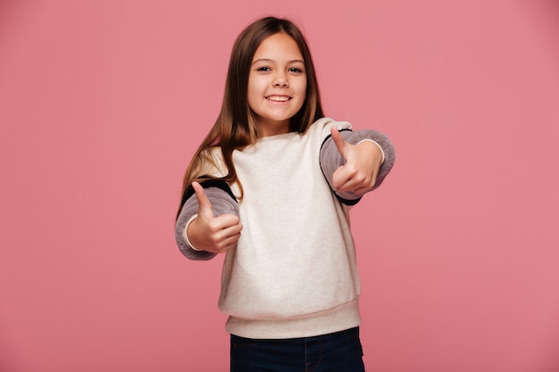 Happy brunette girl showing thumbs up and smiling